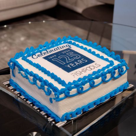 White and blue 125th anniversary birthday cake