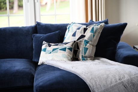 grey throw on blue sofa