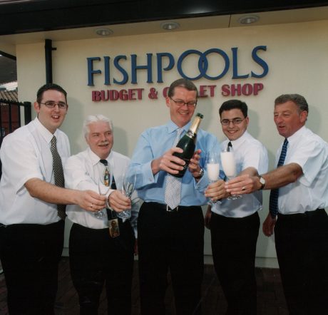 Fishpools team celebrating the budget shop opening with champagne